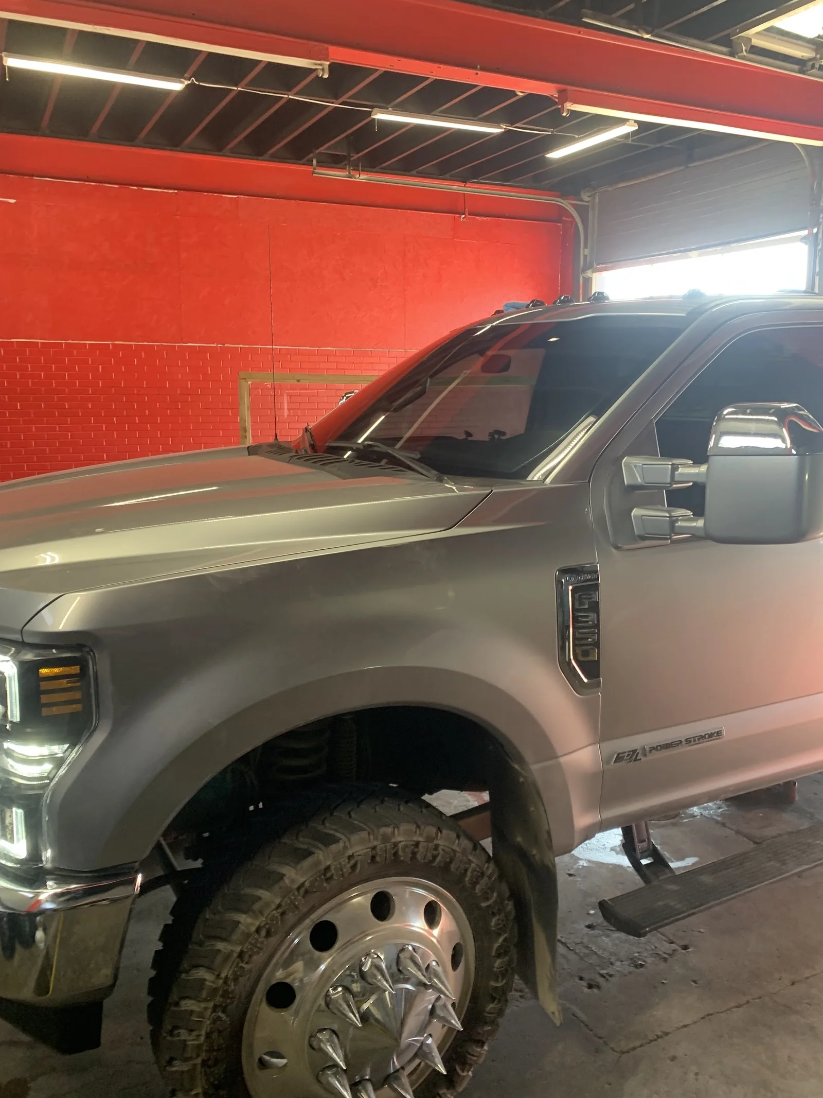 Inside Mr tint of midland llc — shop interior and work bay